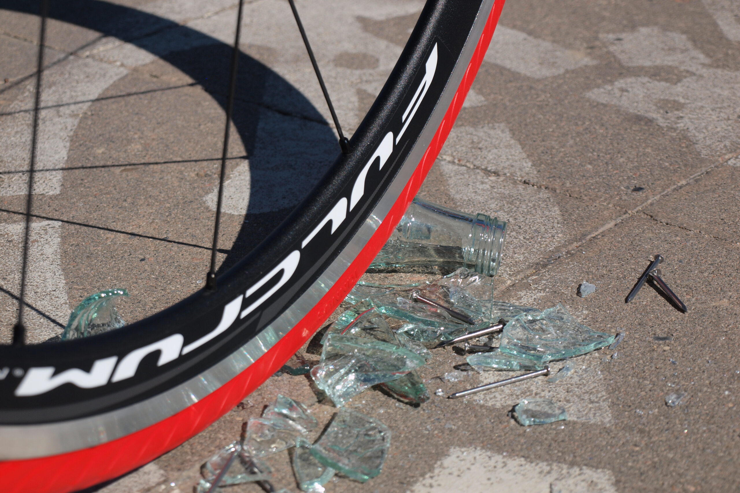 Tannus anti-puncture solid wheel on top of broken glass from a glass bottle.