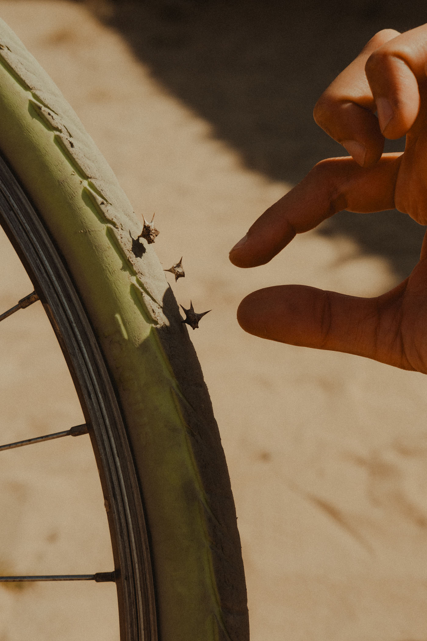 Tannus anti-puncture solid wheel with spikes driven in and one hand removing the spikes