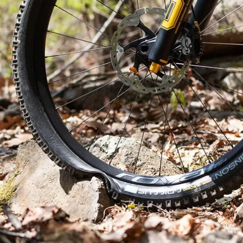 MTB wheel hitting a rock and hitting a "rim", which with the Tannus Armoru anti-puncture protector would be protecting the rim.